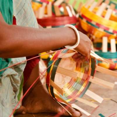 Woman working with bamboo objects sitting around a place unique photo